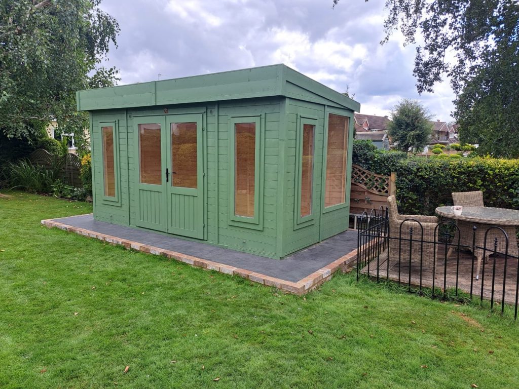 Freshly painted green cabin with a crisp, clean look.