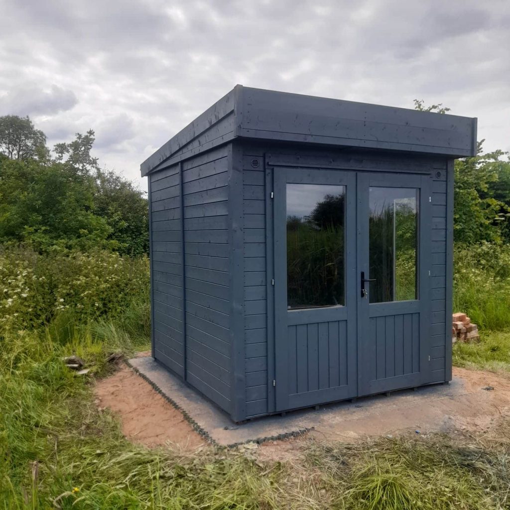 Freshly painted garden shed with a clean, vibrant finish.