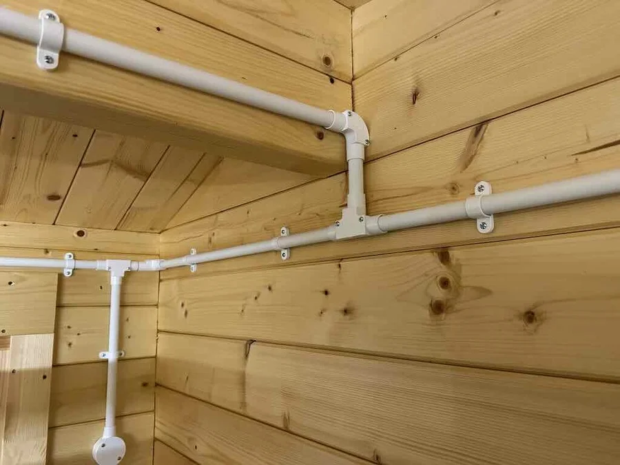 Exposed electric wires running along the interior of a cabin.